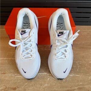 Nike White Running Sneakers W Nike Revolution 8 Wide with Purple Swoosh Accents.